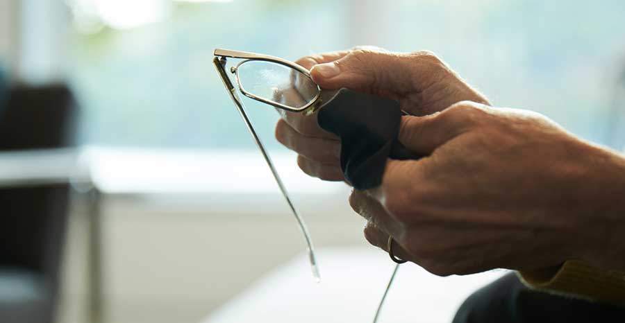hands cleaning glasses
