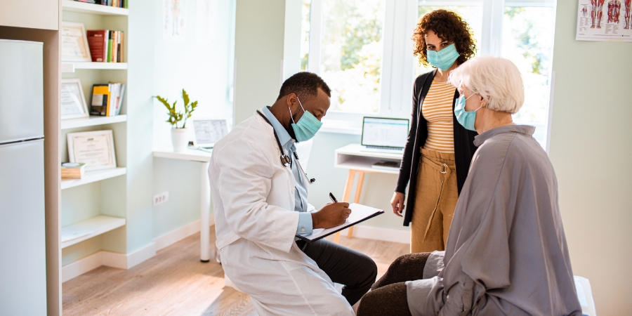Close up of a senior woman and her daughter at a doctors appointment