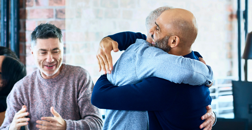 Two men hugging each other in happy moments