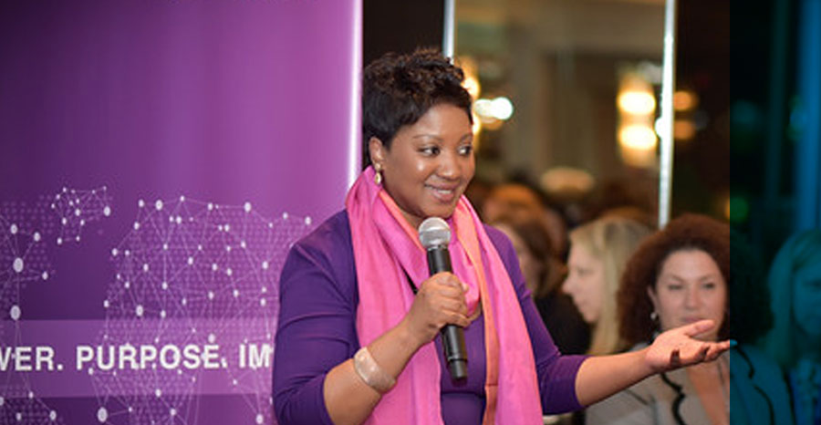 A lady holding speaker educating at women’s forum