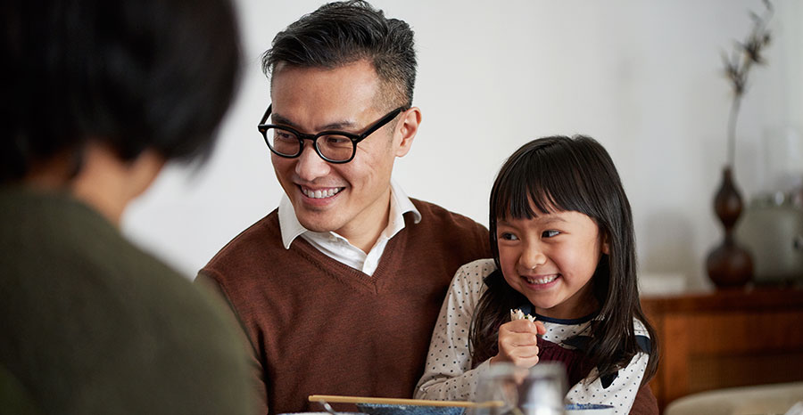 Child sitting on father's lap