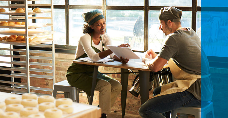 Two people sitting in cafe and discussing on work