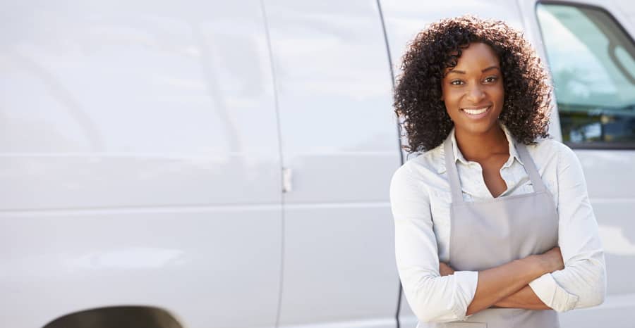 Women standing in front of a truck folding her hands