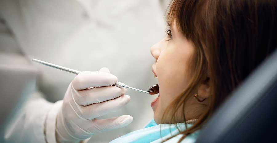 Child taking a dental exam