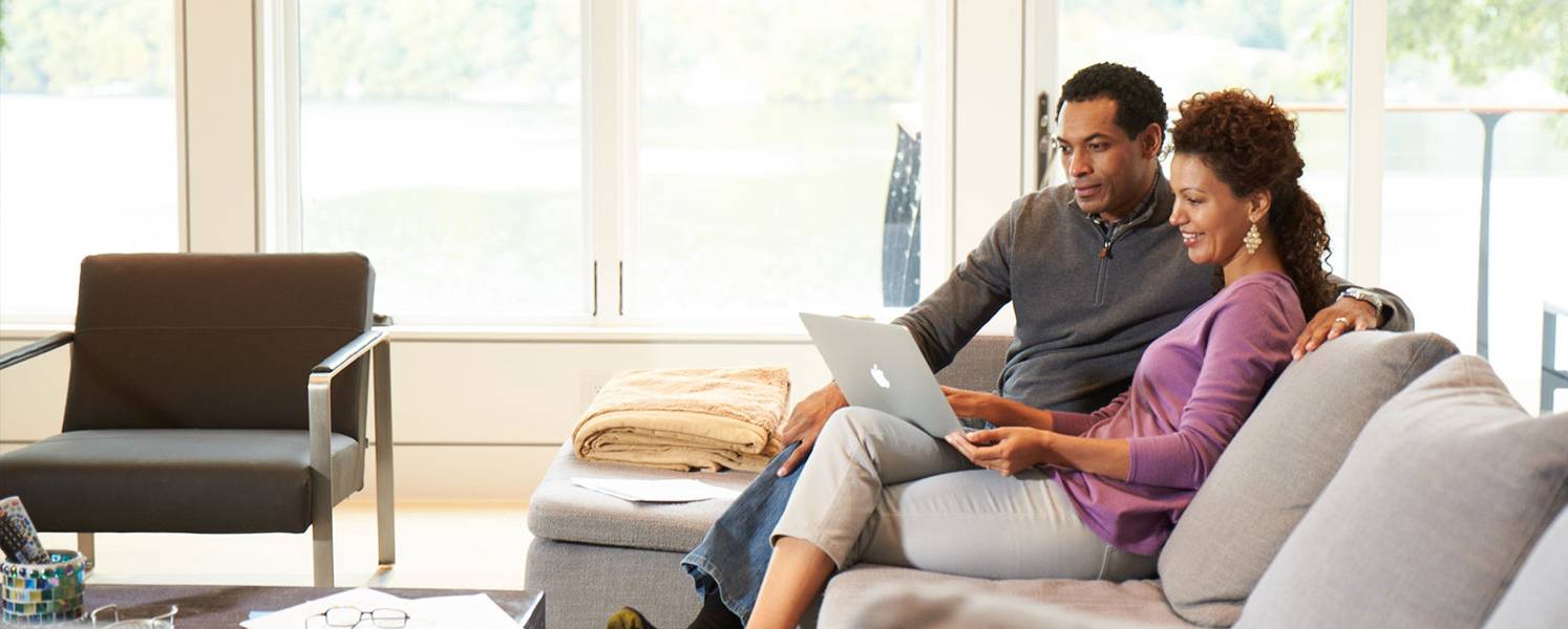 A couple discussing enrollment options with a representative