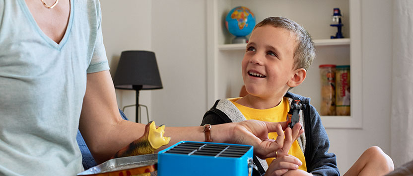 A boy smiling at his mother