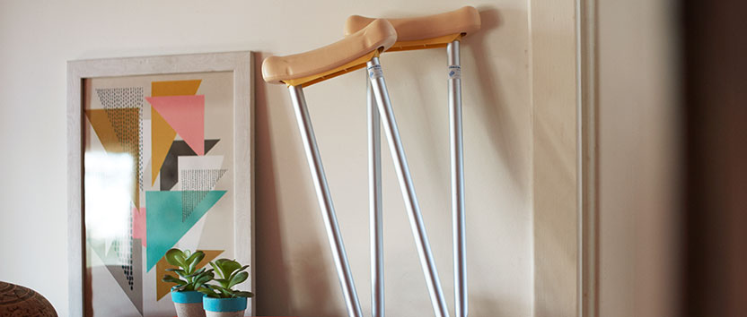A pair of crutches set against a wall
