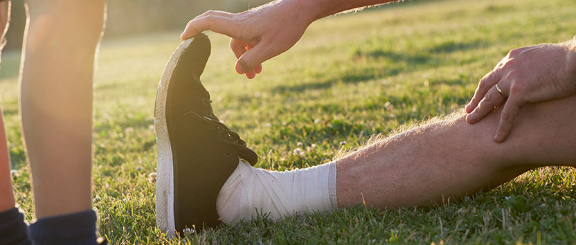 Soccer playing stretching on a field