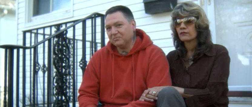 A couple seated on porch steps