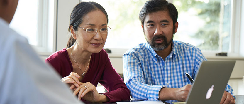 A couple speaking with an agent