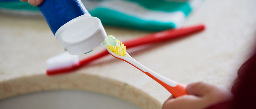Applying toothpaste on toothbrush