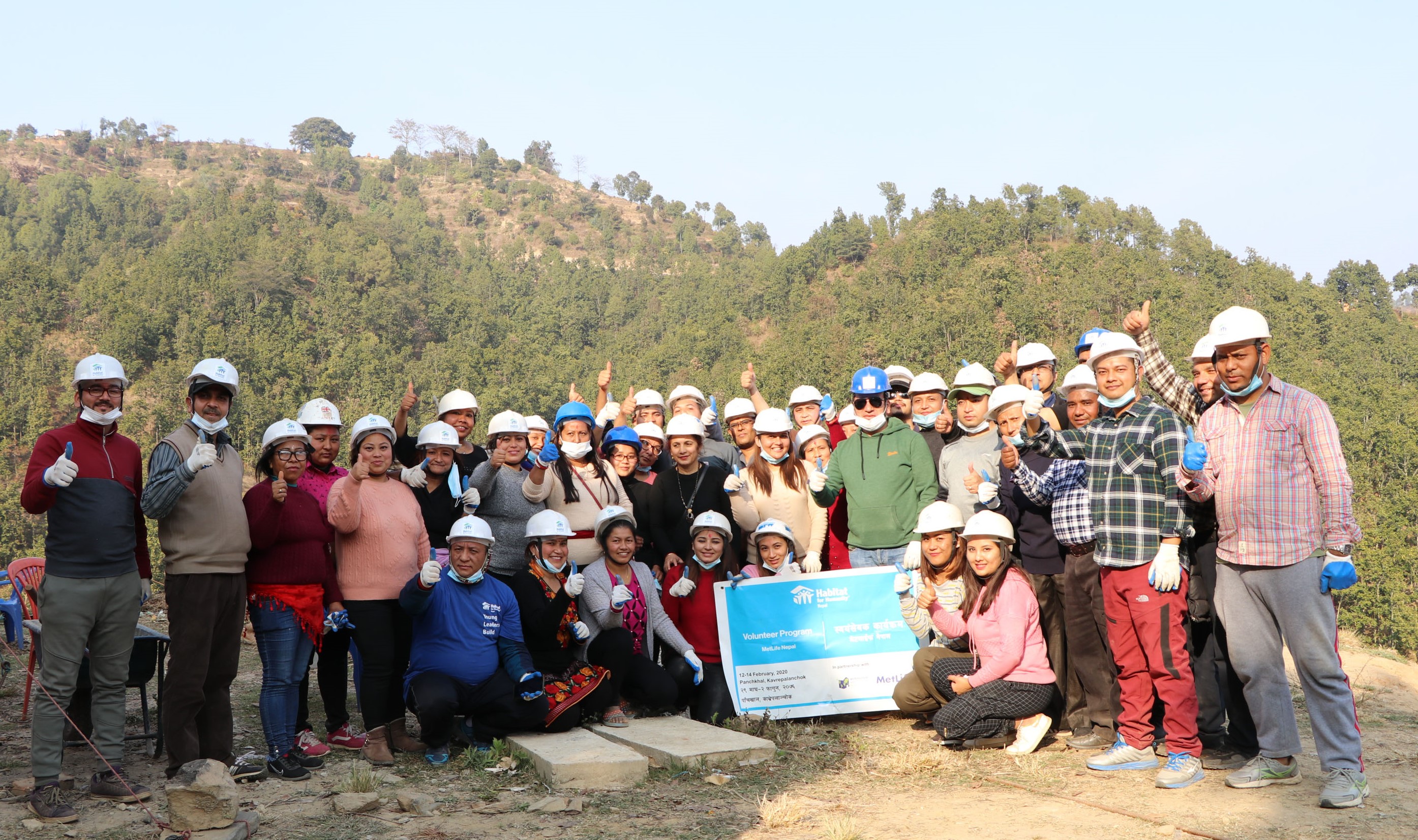 Employees in Nepal participate in a Habitat for Humanity build